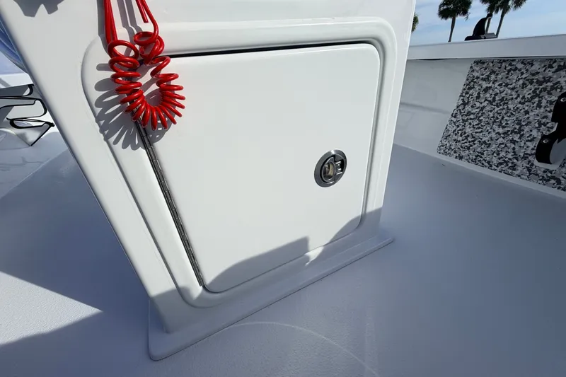 Slide: The Image of 2021 Hell's Bay Marathon boat compartment with red coiled safety lanyard. - 60