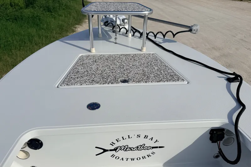 Slide: The Image of 2021 Hell's Bay Marathon boat deck with trolling motor and storage compartments. - 32