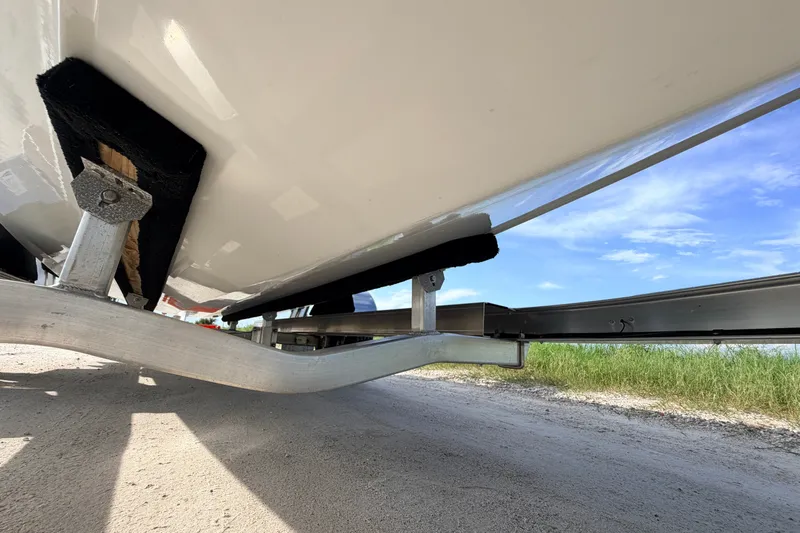 Slide: The Image of 2021 Hell's Bay Marathon boat on trailer, underside view, clear sky background. - 10