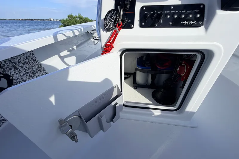 Slide: The Image of 2021 Hell's Bay Marathon boat console with open storage compartment, showcasing interior equipment. - 61