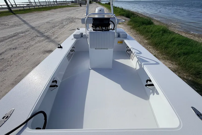Slide: The Image of 2021 Hell's Bay Marathon boat on a coastal road, showcasing spacious deck and sleek design. - 54