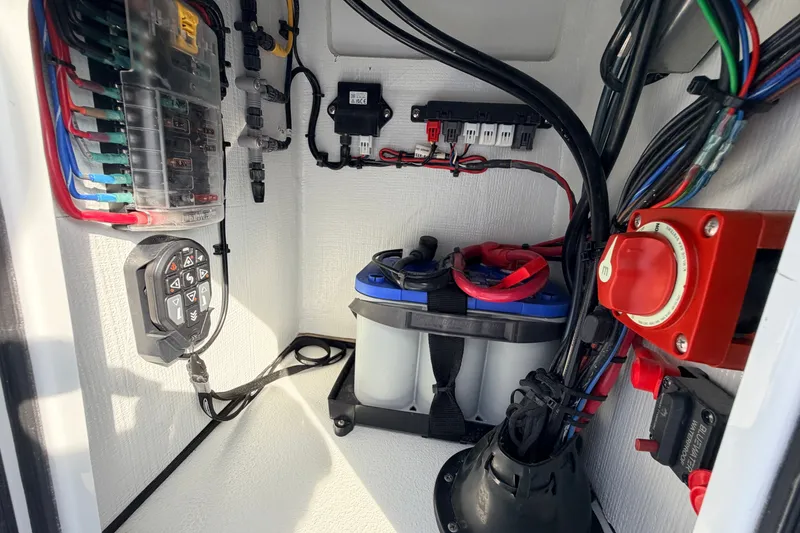 Slide: The Image of Electrical system inside a 2021 Hell's Bay Marathon boat, featuring wiring and battery setup. - 62