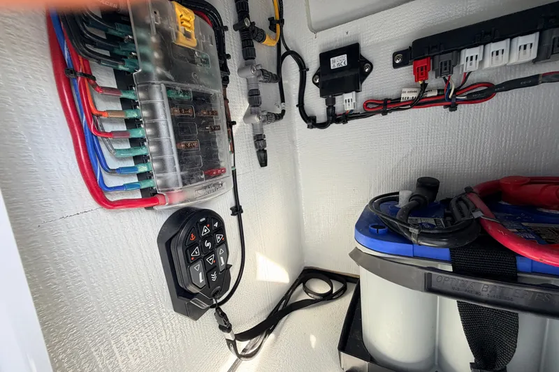 Slide: The Image of Electrical system inside a 2021 Hell's Bay Marathon boat, featuring wiring and battery setup. - 63