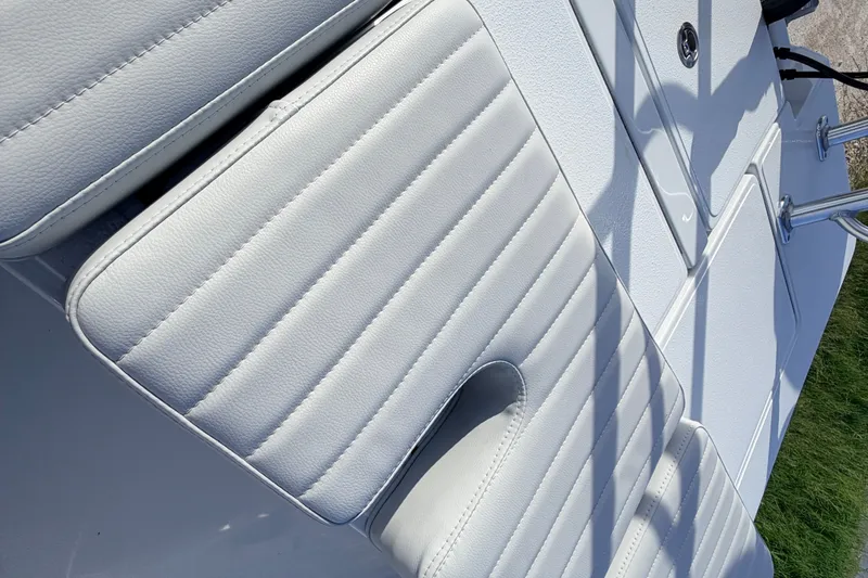 Slide: The Image of 2021 Hell's Bay Marathon boat interior with white cushioned seating and sleek design. - 70