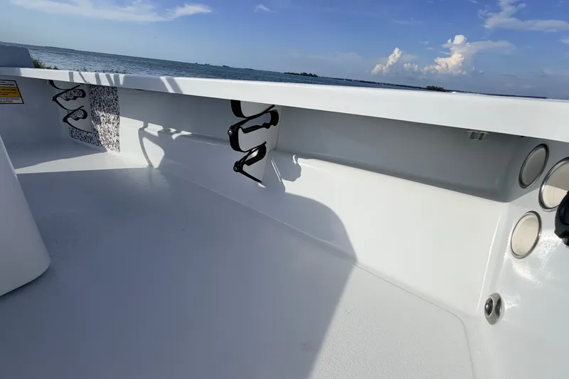 Slide: The Image of 2021 Hell's Bay Marathon boat interior with rod holders, ocean view in background. - 52