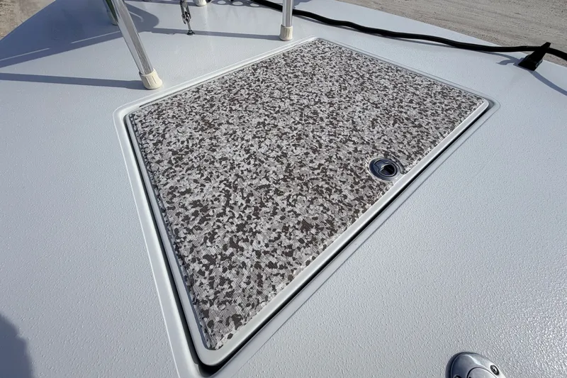 Slide: The Image of 2021 Hell's Bay Marathon boat deck with speckled hatch cover and stainless steel hardware. - 39