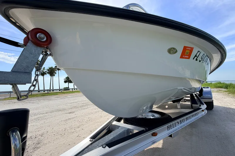 Slide: The Image of 2021 Hell's Bay Marathon boat on trailer, parked near a scenic waterfront. - 11