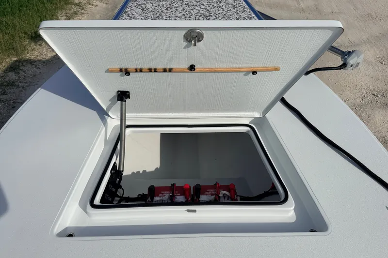 Slide: The Image of Open storage compartment on a 2021 Hell's Bay Marathon boat, showing interior details. - 41