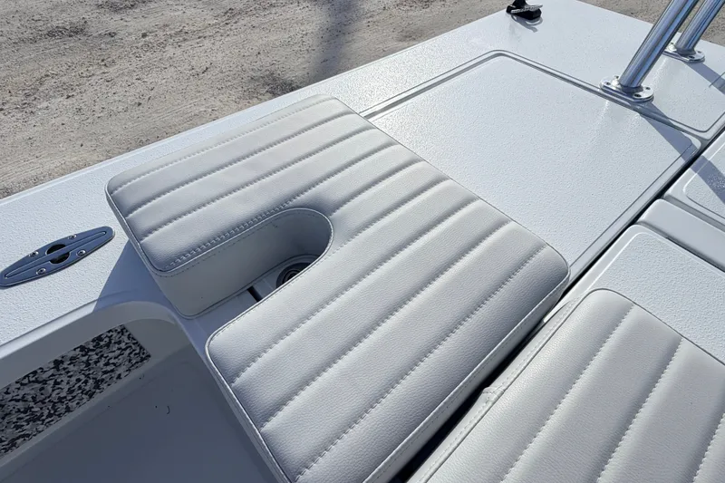 Slide: The Image of 2021 Hell's Bay Marathon boat seat with textured white upholstery and storage compartment. - 68