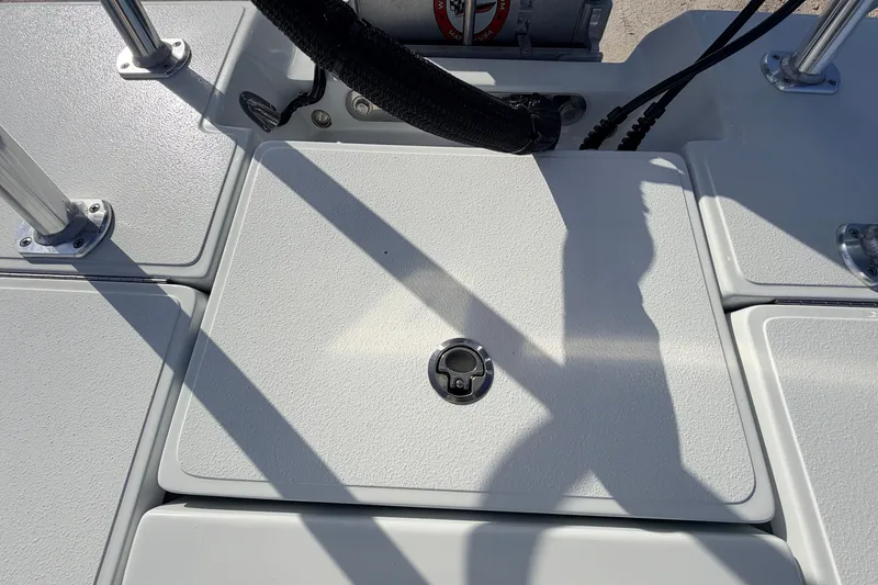 Slide: The Image of 2021 Hell's Bay Marathon boat deck with textured surface and metal fittings. - 74