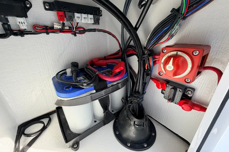 Slide: The Image of 2021 Hell's Bay Marathon boat battery setup with wiring and switch panel. - 64