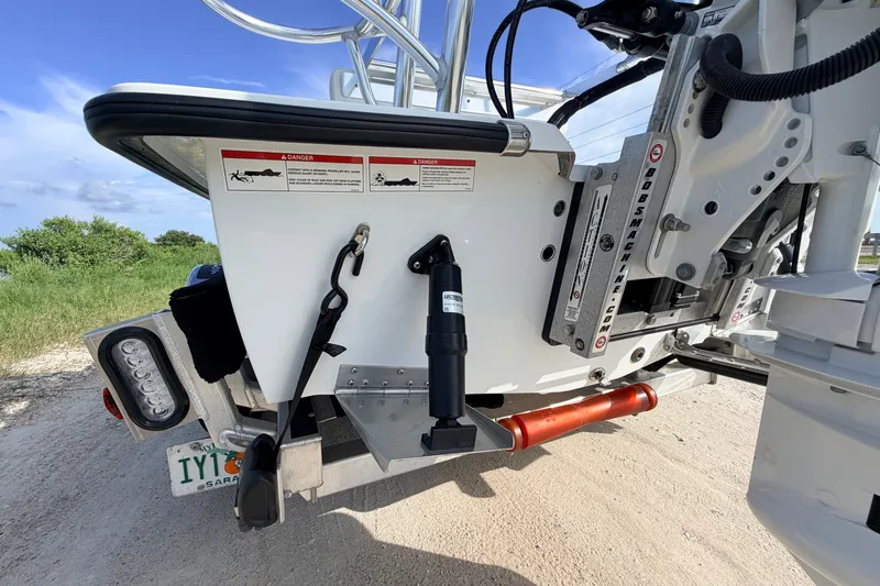 Slide: The Image of 2021 Hell's Bay Marathon boat transom with hydraulic jack plate and warning labels. - 21