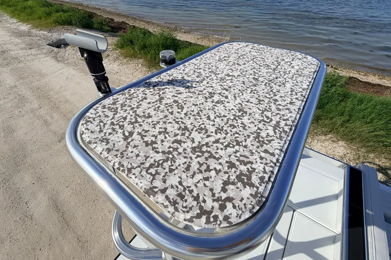 Slide: The Image of 2021 Hell's Bay Marathon boat platform with camo pattern, near shoreline. - 81