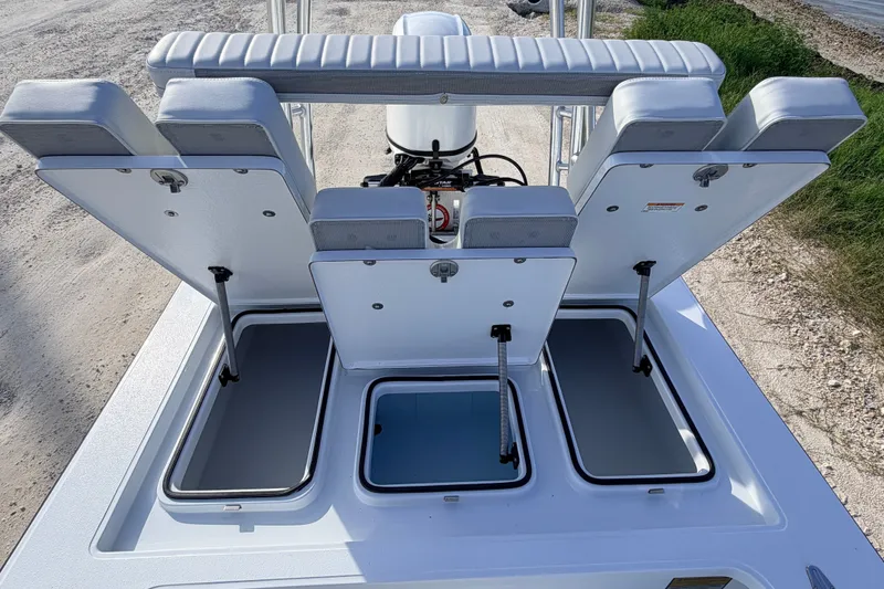 Slide: The Image of 2021 Hell's Bay Marathon boat with open storage compartments and cushioned seating. - 67
