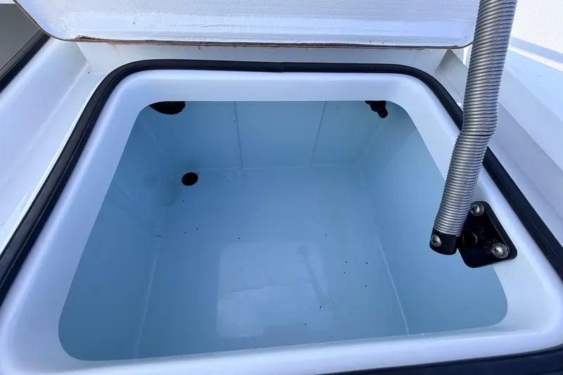 Slide: The Image of Open storage compartment in 2021 Hell's Bay Marathon boat, featuring a clean interior. - 71