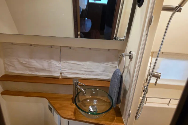 Slide: The Image of Bathroom interior of 2021 Sea Ray Sundancer 350 yacht with glass sink and modern fixtures. - 49