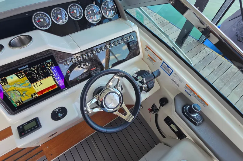 Slide: The Image of 2021 Sea Ray Sundancer 350 helm with advanced navigation and control systems. - 33