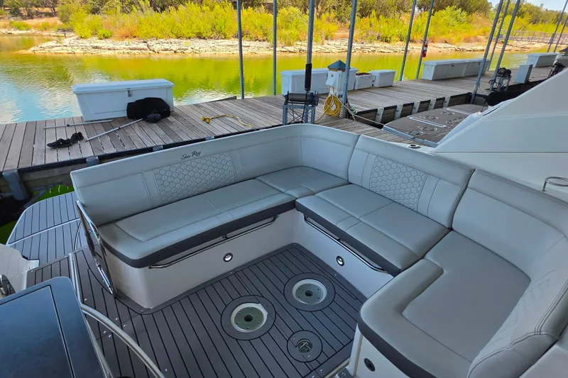 Slide: The Image of Luxurious seating area on 2021 Sea Ray Sundancer 350 yacht, docked by a scenic lake. - 20