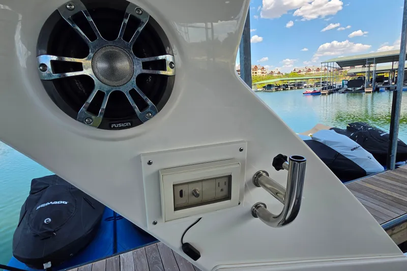 Slide: The Image of Speaker and outlet on 2021 Sea Ray Sundancer 350 boat, docked by a marina. - 28