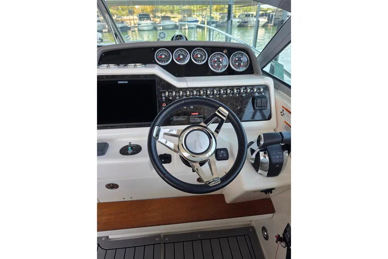 Slide: The Image of Helm of 2021 Sea Ray Sundancer 350 with steering wheel and control panel. - 26