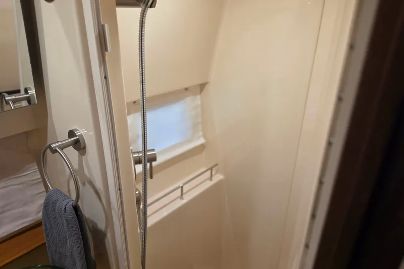 Slide: The Image of Bathroom interior of 2021 Sea Ray Sundancer 350 yacht, featuring shower and towel rack. - 51