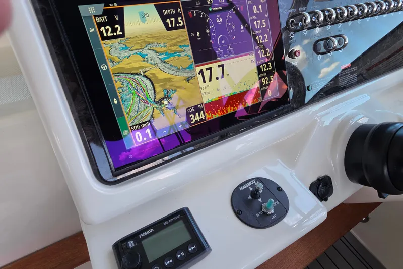 Slide: The Image of Dashboard of a 2021 Sea Ray Sundancer 350 with navigation and control displays. - 32
