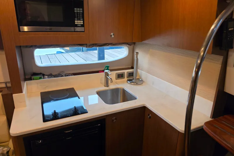 Slide: The Image of Modern kitchen interior of 2021 Sea Ray Sundancer 350 yacht with stove and sink. - 44