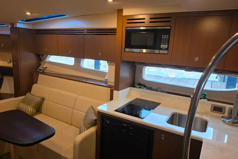 Slide: The Image of Interior of 2021 Sea Ray Sundancer 350 yacht with modern kitchen and seating area. - 43