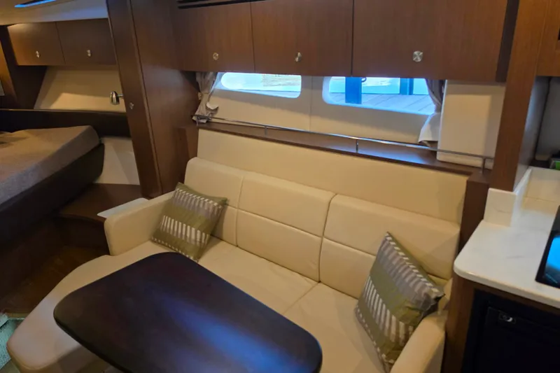 Slide: The Image of Interior of 2021 Sea Ray Sundancer 350 yacht with cozy seating and wooden cabinetry. - 45