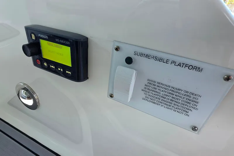 Slide: The Image of Control panel on 2021 Sea Ray Sundancer 350 with submersible platform warning. - 27