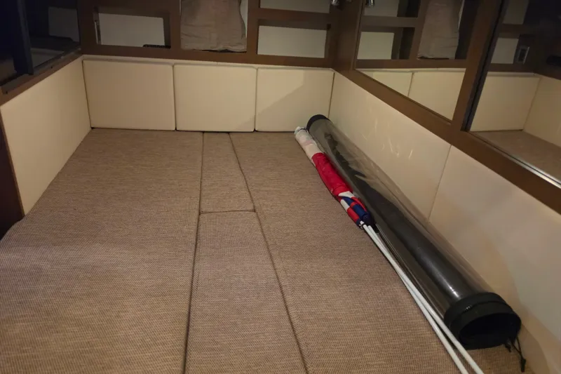 Slide: The Image of Interior cabin of 2021 Sea Ray Sundancer 350 with beige upholstery and stored equipment. - 52