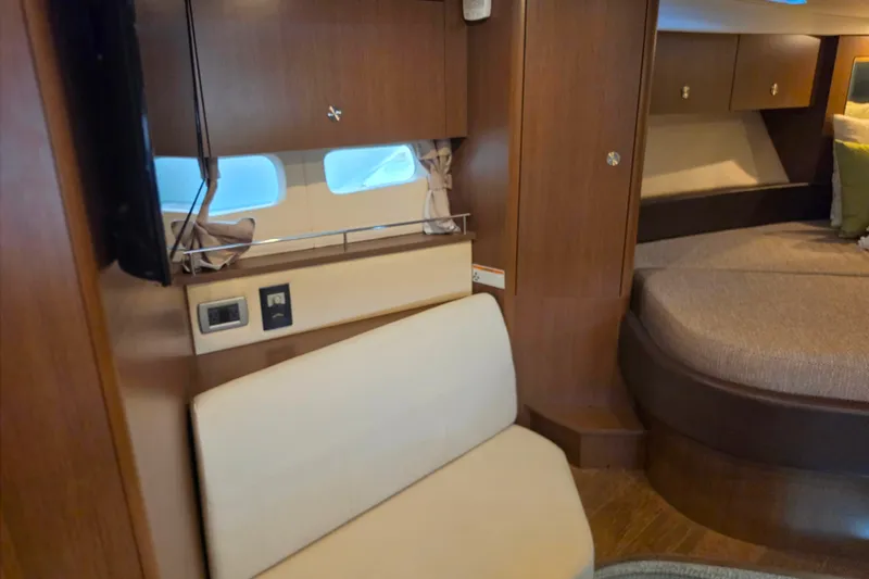 Slide: The Image of Interior of 2021 Sea Ray Sundancer 350 yacht with seating and bed area. - 46