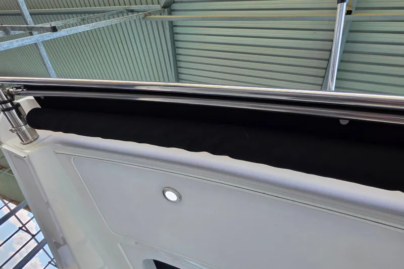 Slide: The Image of 2021 Sea Ray Sundancer 350 boat railing and deck detail under a metal roof. - 29