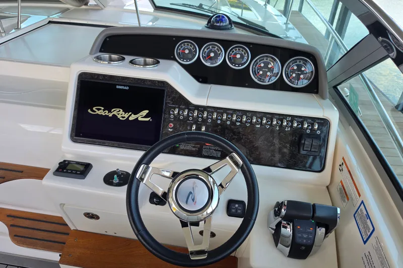 Slide: The Image of 2021 Sea Ray Sundancer 350 helm with modern controls and navigation display. - 24