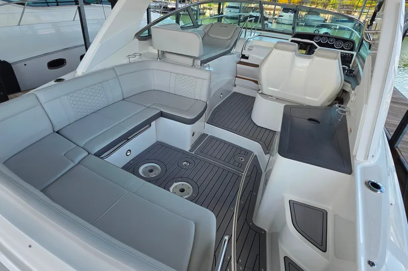 Slide: The Image of 2021 Sea Ray Sundancer 350 interior with sleek seating and modern dashboard design. - 16