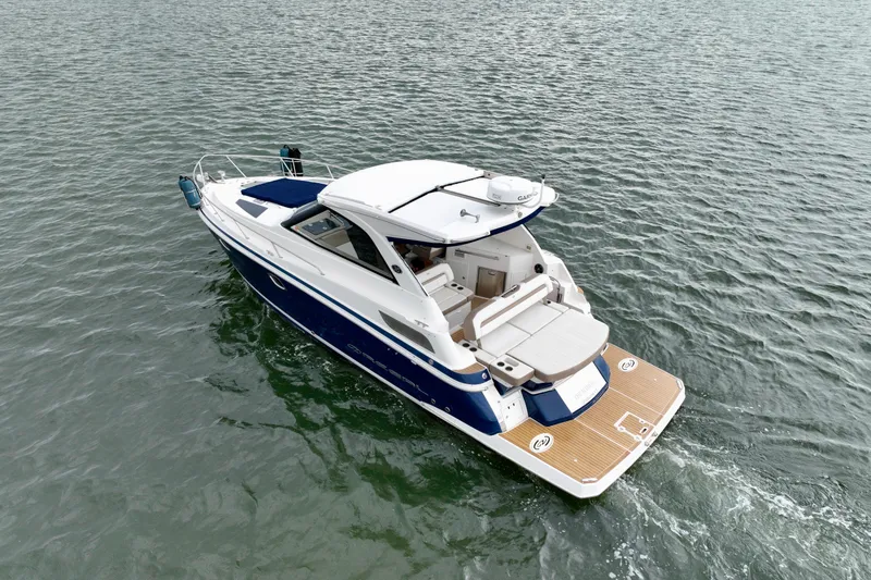 Slide: The Image of 2017 Regal 35 Sport Coupe cruising on open water, showcasing sleek design and luxury features. - 1
