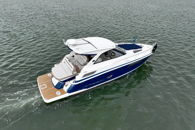 Slide: The Image of 2017 Regal 35 Sport Coupe cruising on open water, showcasing sleek design and luxury features. - 0