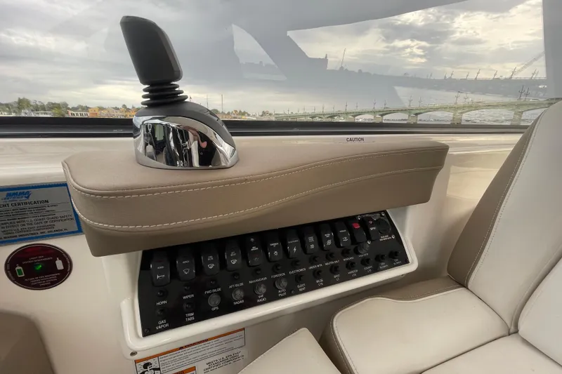 Slide: The Image of 2017 Regal 35 Sport Coupe control panel with joystick and switches, interior view. - 26