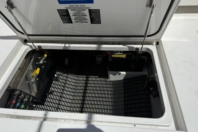 Slide: The Image of An open storage compartment on a boat with batteries and equipment. - 18