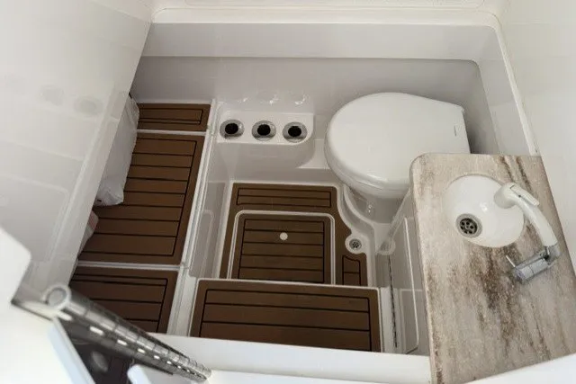 Slide: The Image of 2021 Valhalla Boatworks V-33 interior bathroom with toilet, sink, and wooden flooring. - 19