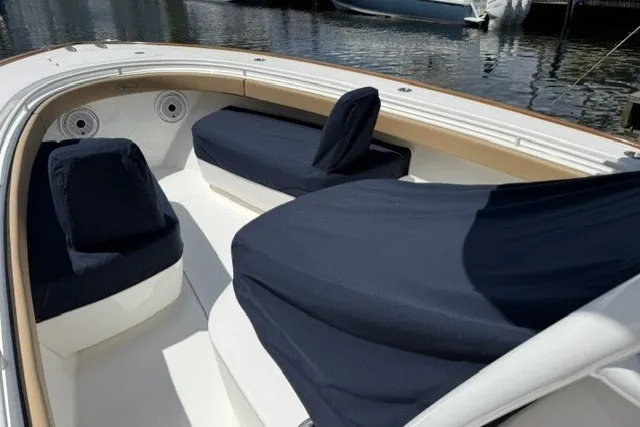 Slide: The Image of 2021 Valhalla Boatworks V-33 interior with navy covers, docked by the water. - 13