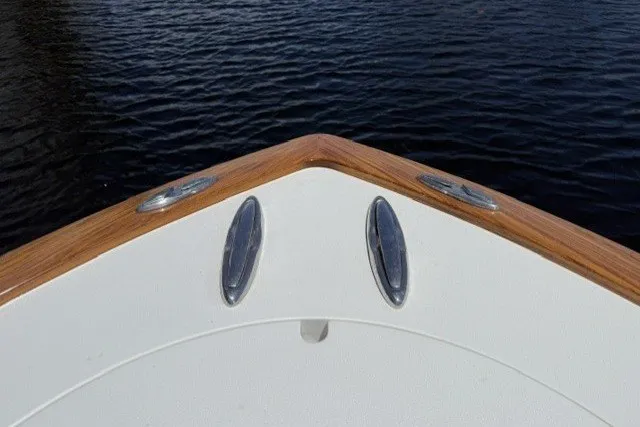 Slide: The Image of Bow of 2021 Valhalla Boatworks V-33 on water, featuring sleek design and wood accents. - 16