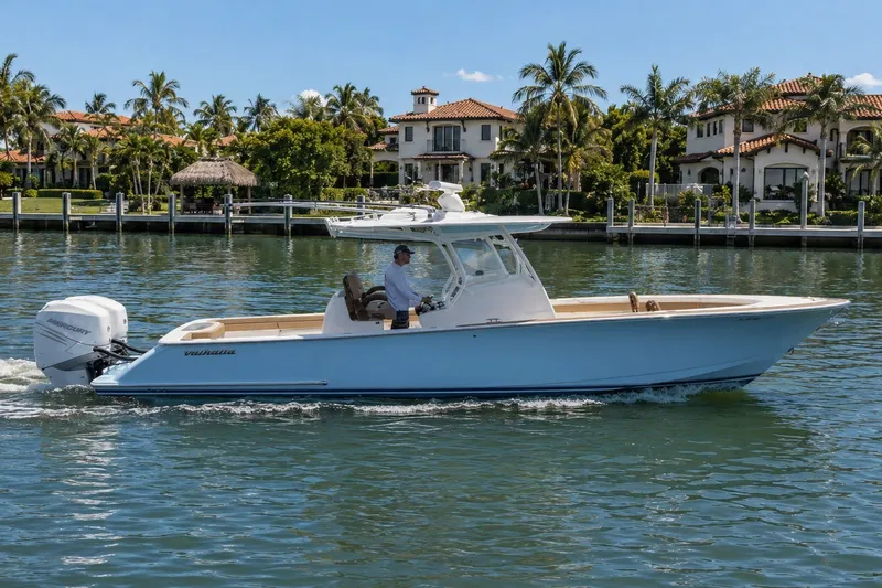 The Image of 2021 Valhalla Boatworks V-33 cruising on a sunny day near waterfront homes. - 0