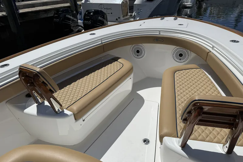 Slide: The Image of 2021 Valhalla Boatworks V-33 interior with tan quilted seating and dual Mercury engines. - 14