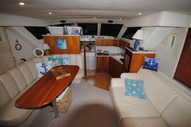 Slide: The Image of Interior of a 2000 Silverton 351 Sedan yacht with cozy seating and nautical decor. - 13