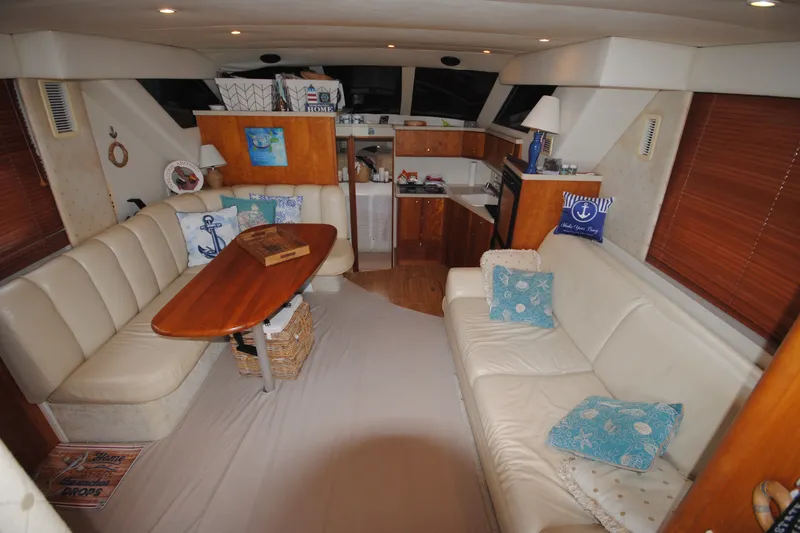 Slide: The Image of Interior of a 2000 Silverton 351 Sedan yacht with cozy seating and wooden accents. - 14