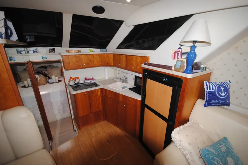 Slide: The Image of Interior of a 2000 Silverton 351 Sedan yacht with cozy kitchen and seating area. - 15