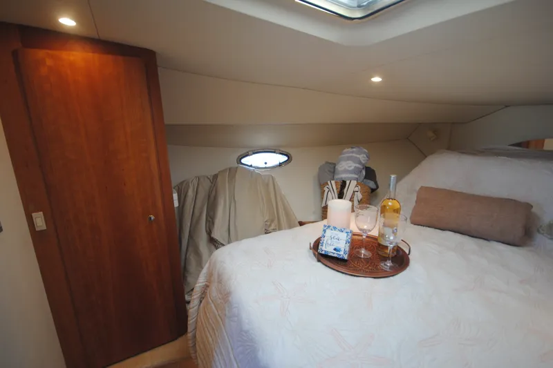 Slide: The Image of Luxurious cabin interior of 2000 Silverton 351 Sedan with cozy bed and wine setup. - 21