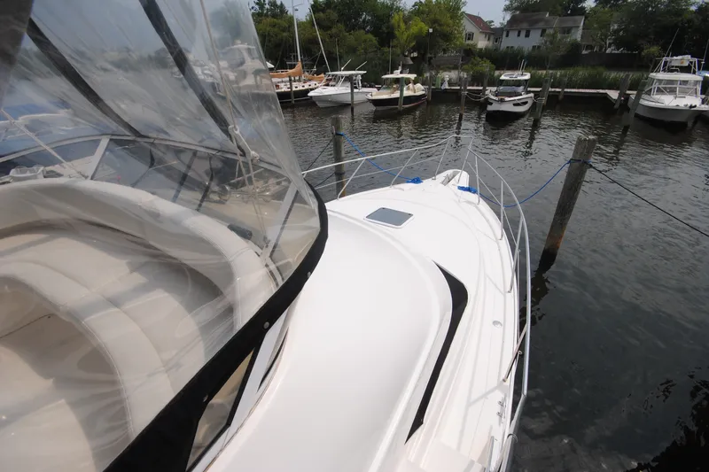 Slide: The Image of 2000 Silverton 351 Sedan yacht docked at marina, featuring sleek design and spacious deck. - 6