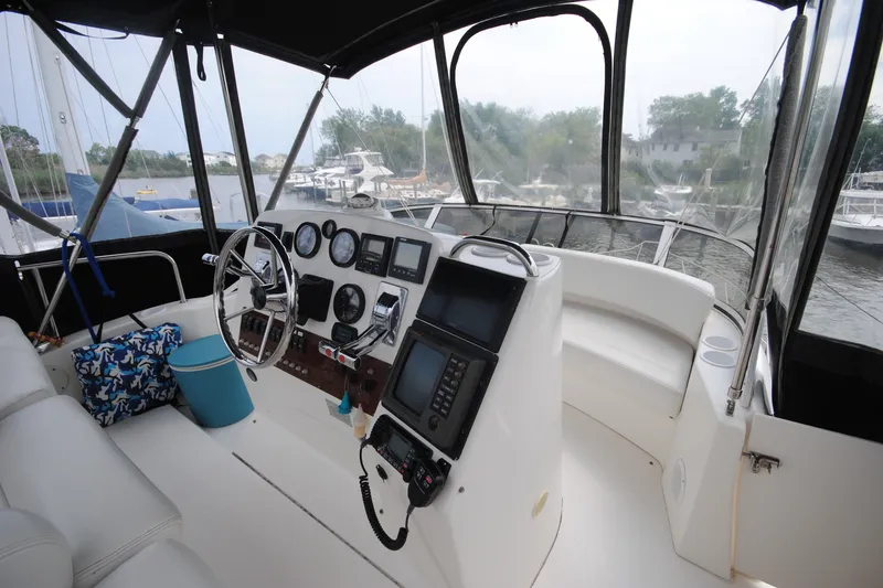 Slide: The Image of Interior helm of 2000 Silverton 351 Sedan yacht with steering wheel and navigation instruments. - 9